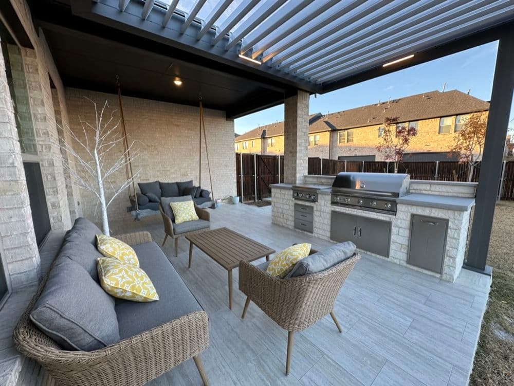 Outdoor patio with seating, grill, and modern design in a residential backyard.